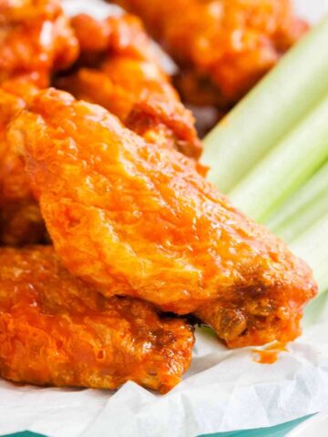 Buffalo Chicken Wings on a plate with celery sticks