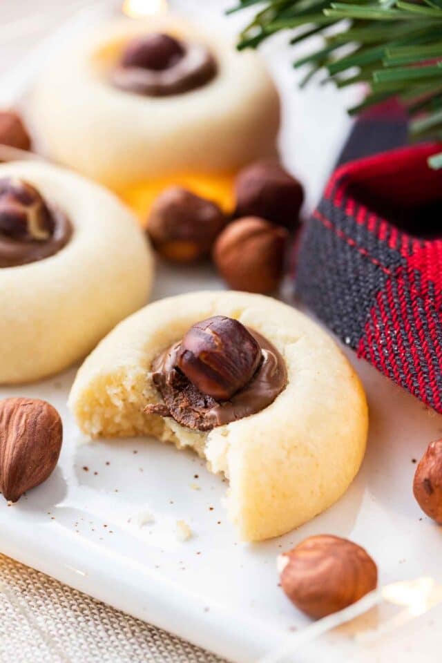 Cookies filled with Nutella and whole hazelnuts on a serving platter