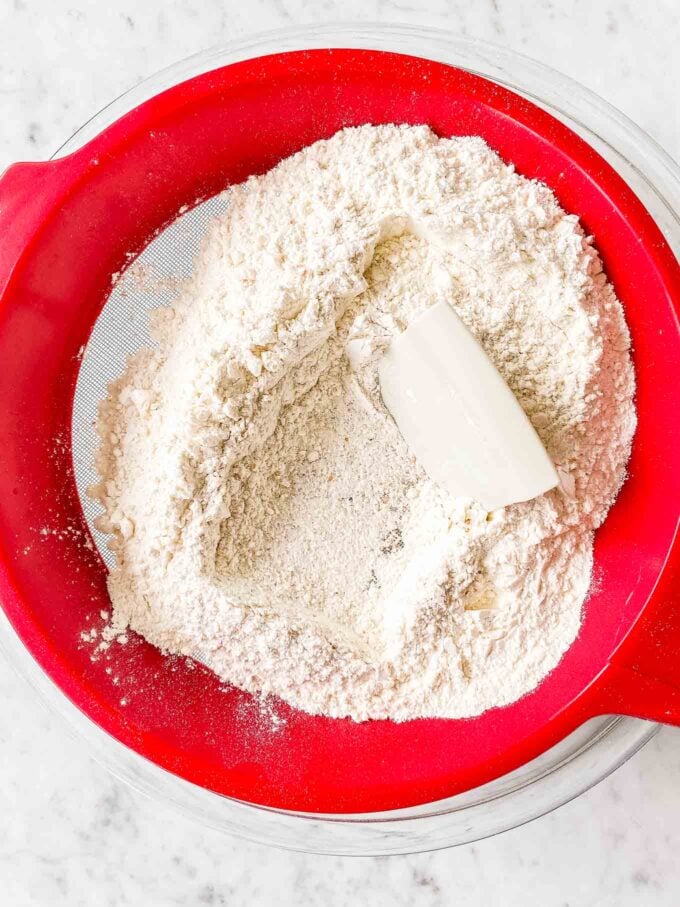 Sifting flour into a bowl
