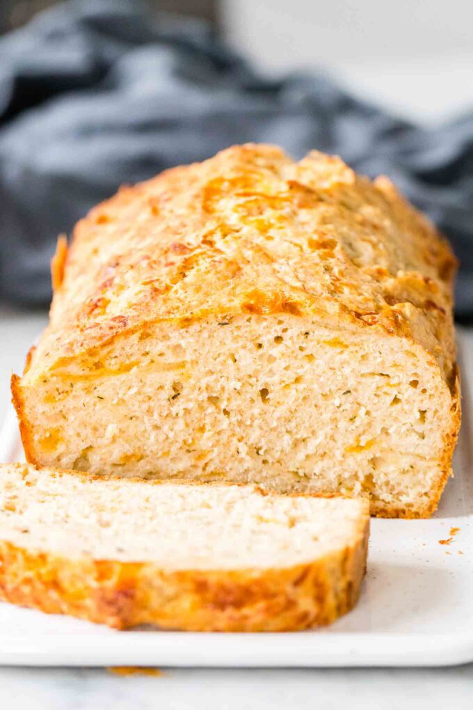 A loaf of beer bread with a slice of bread in front