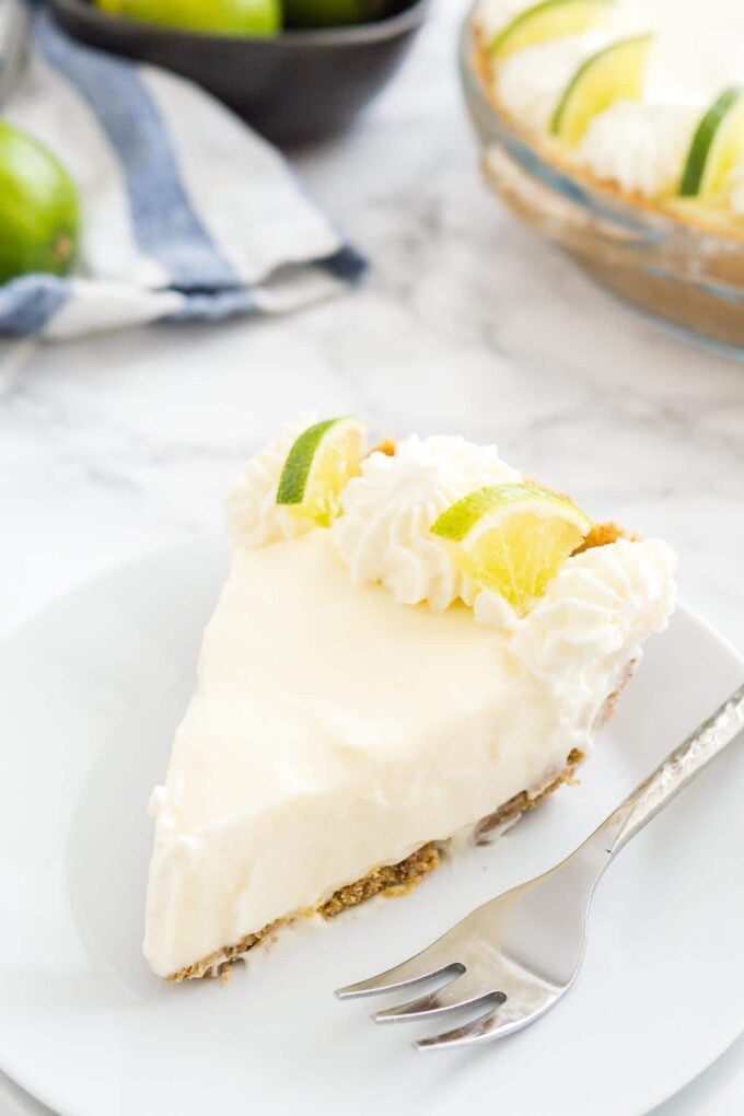 A slice of no bake key lime pie on a plate with a fork