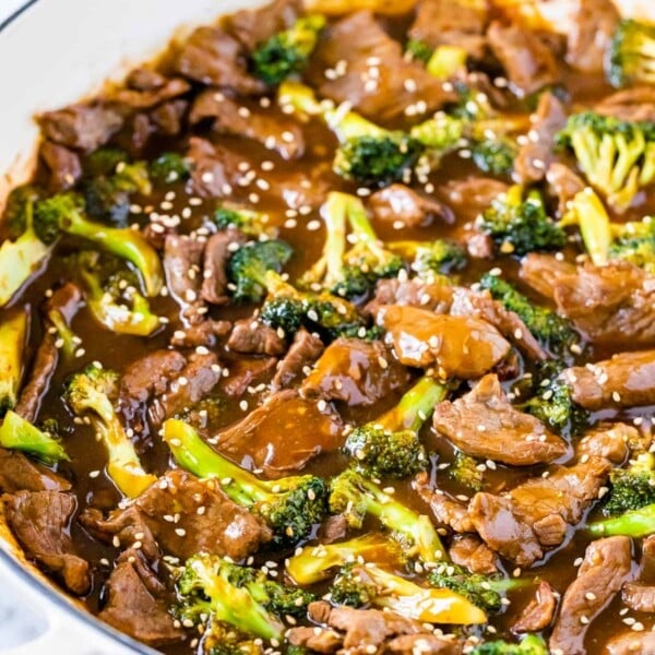 Beef and broccoli stir fry in a white pan