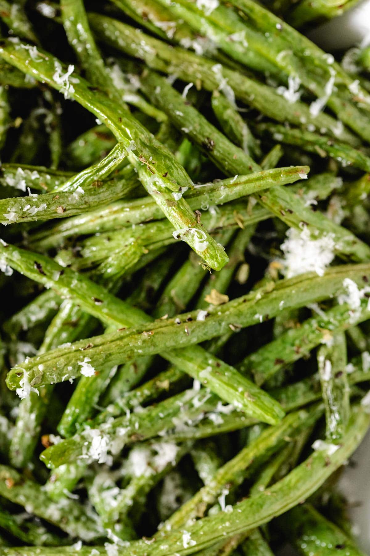 a close up shot of cooked, seasoned green beans 