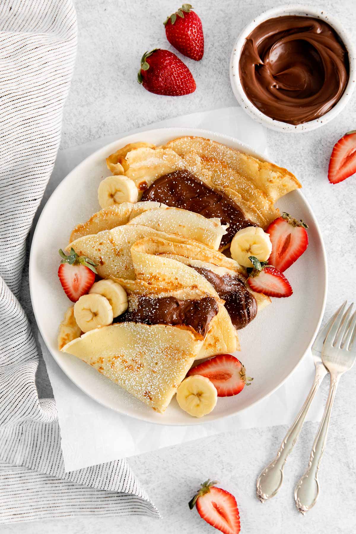 French crepes folded and filled with Nutella on a plate