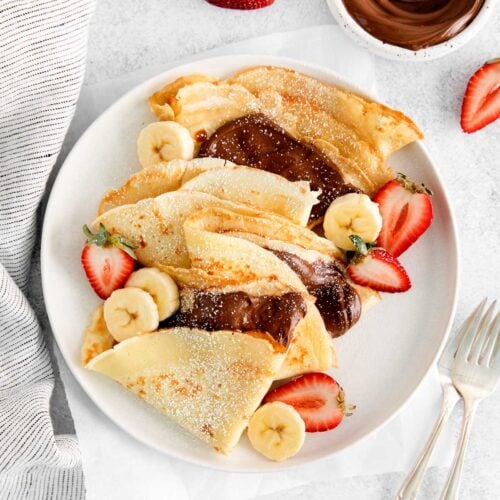 French crepes folded and filled with Nutella on a plate