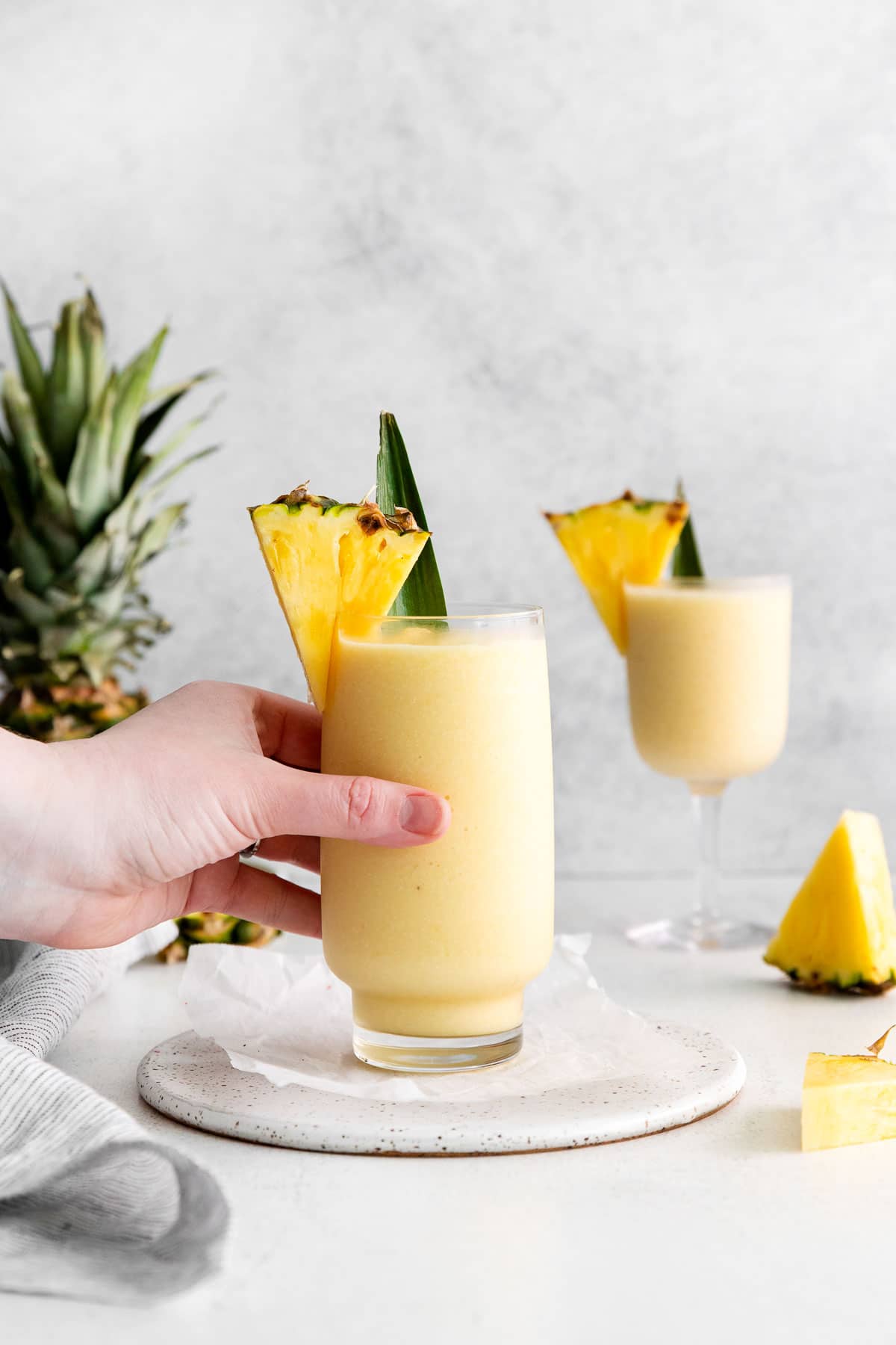 A female hand reaching for a large glass.