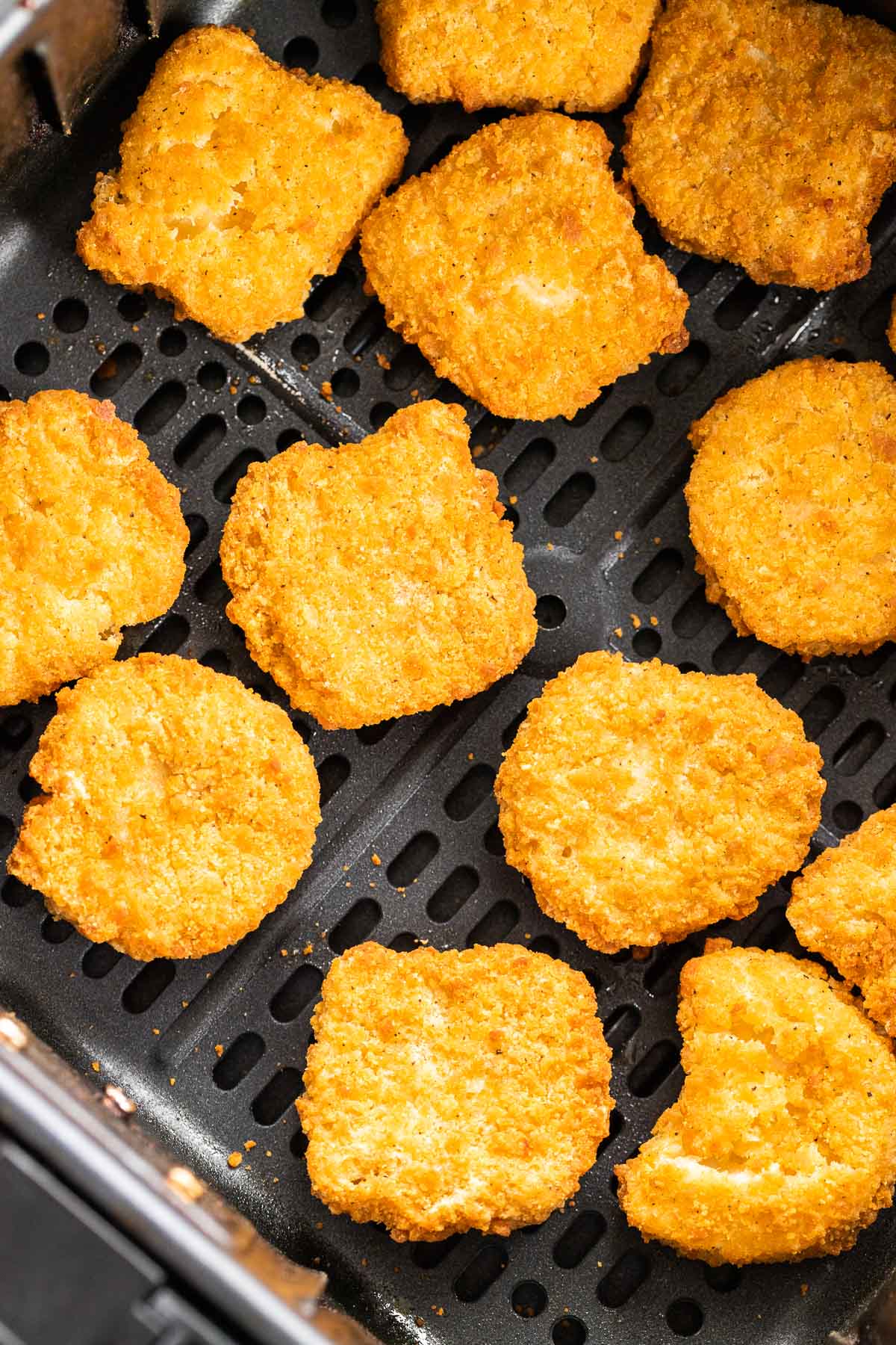 Air fried chicken nuggets in an Air Fryer Basket.