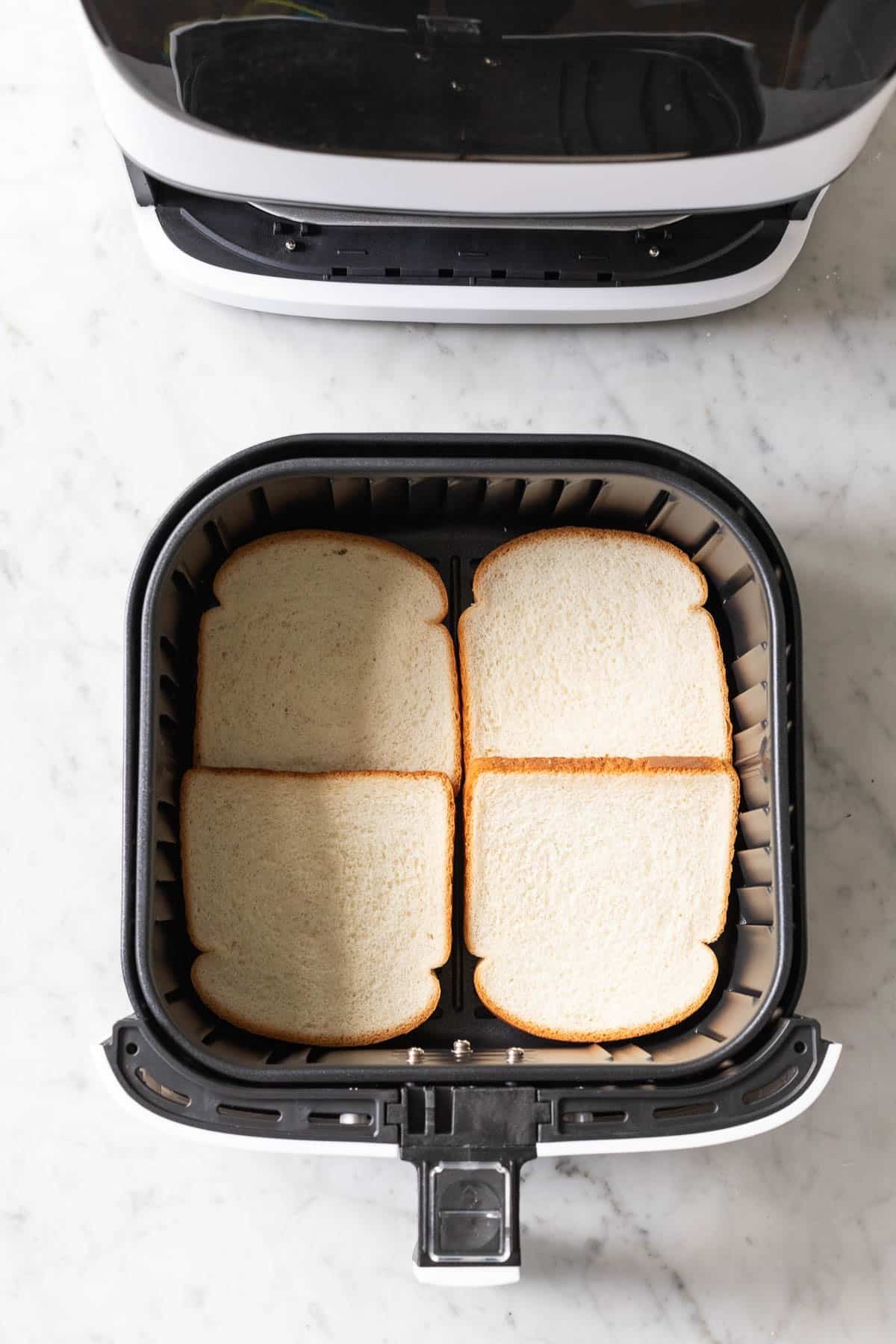 Bread in an Air Fryer basket.