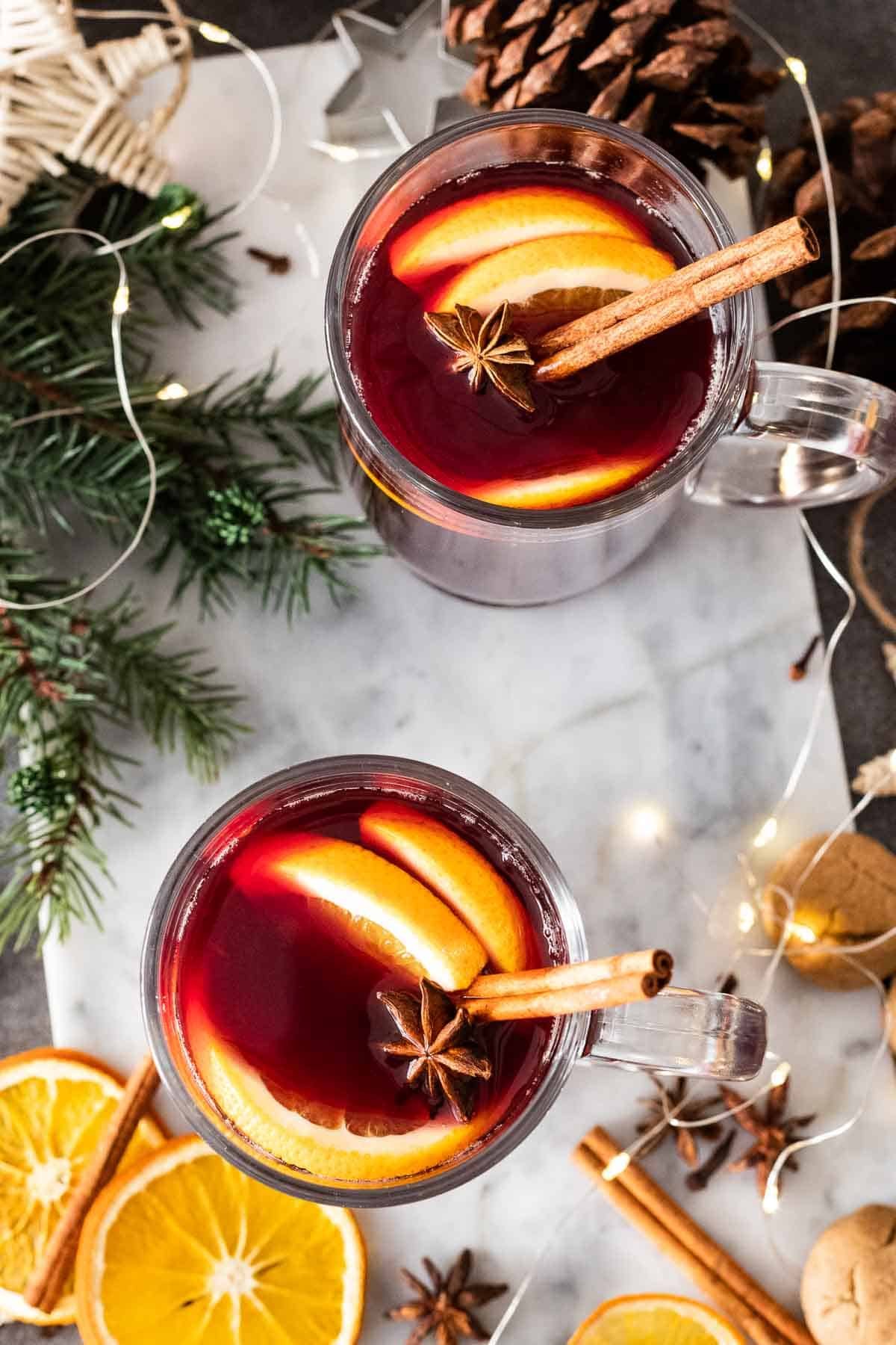 Two glasses of mulled wine on a marble board.