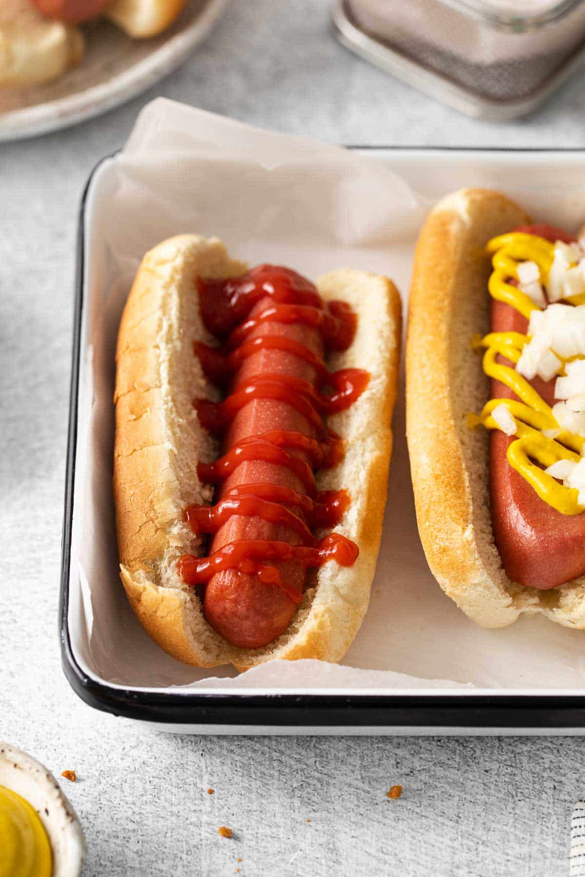 A hot dog garnished with ketchup.