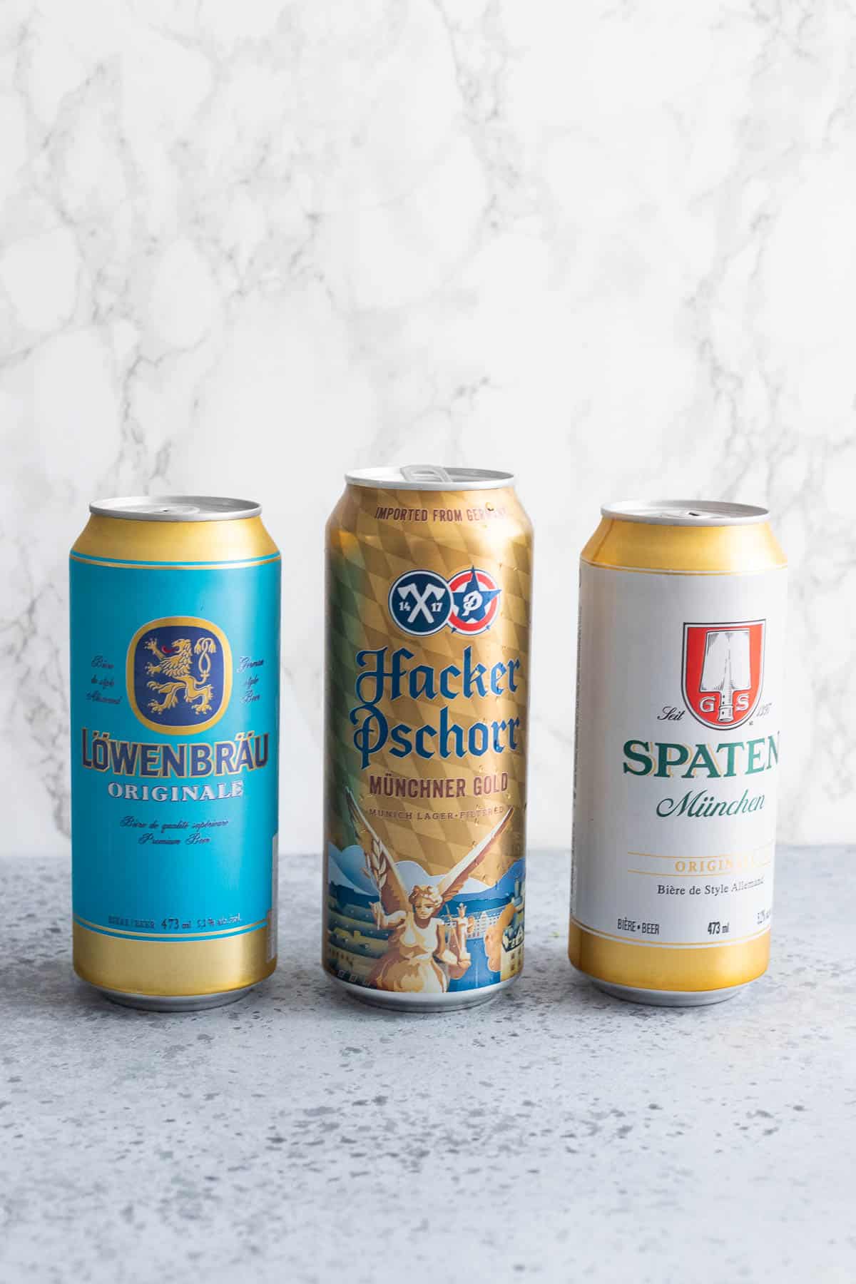 Three different kinds of beers in cans.