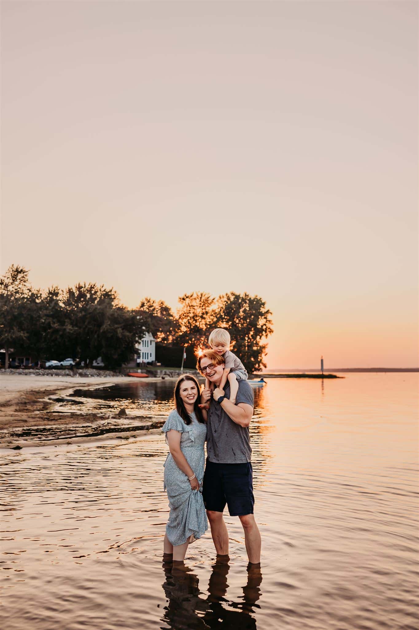 A family picture on the beach at sunset.