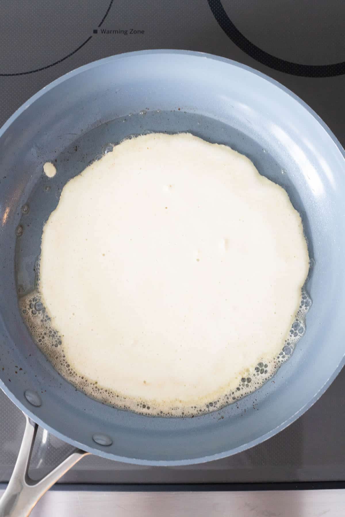 Frying the pancake in a pan.