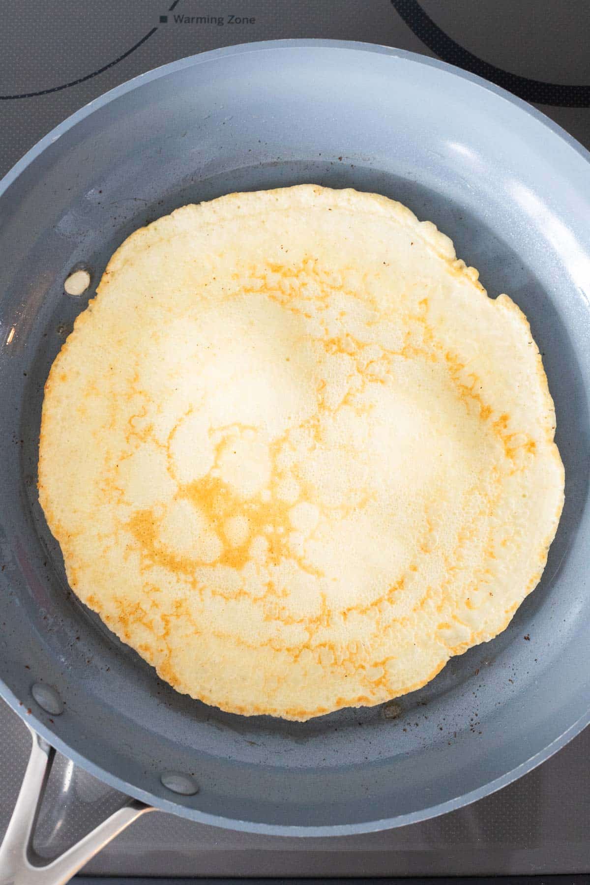 The pancake in a pan after flipping it.