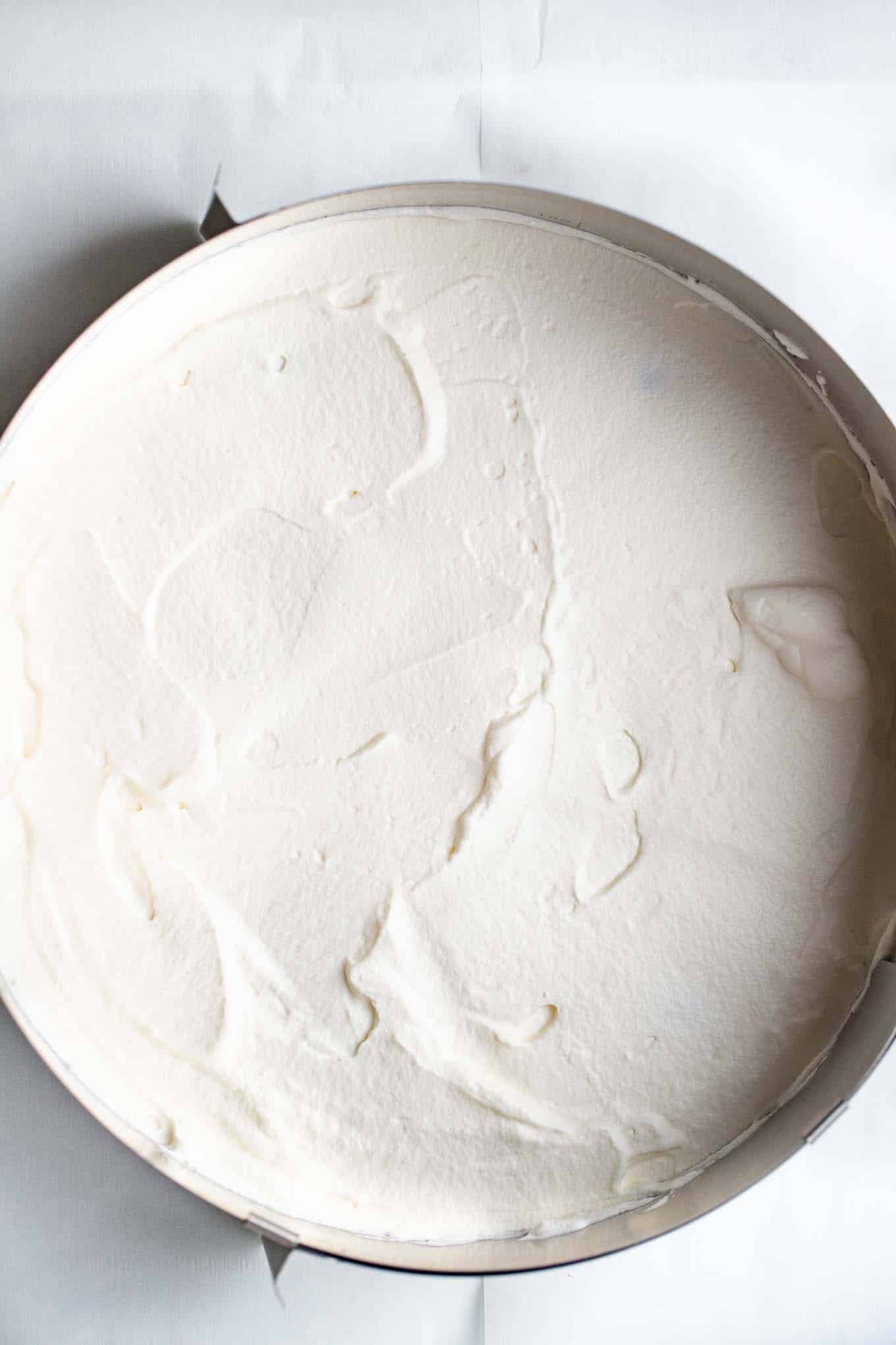Whipped cream on a cake layer.