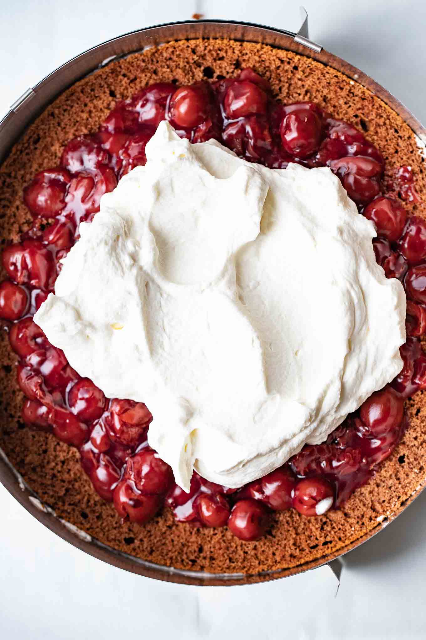 Assembling a Black Forest cake.