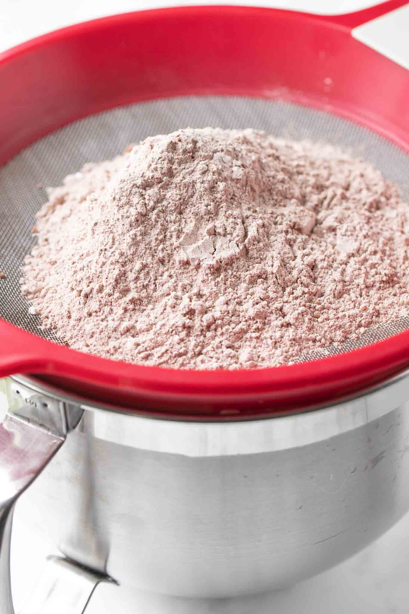 A sieve on top of a bowl.