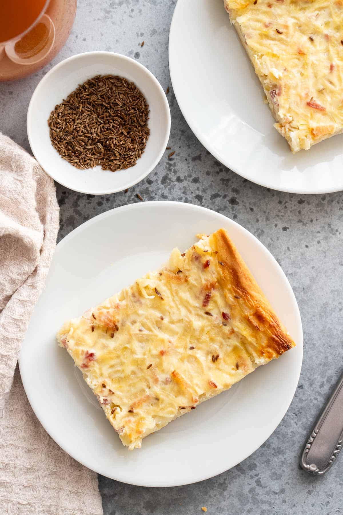 A slice of Zwiebelkuchen on a plate.