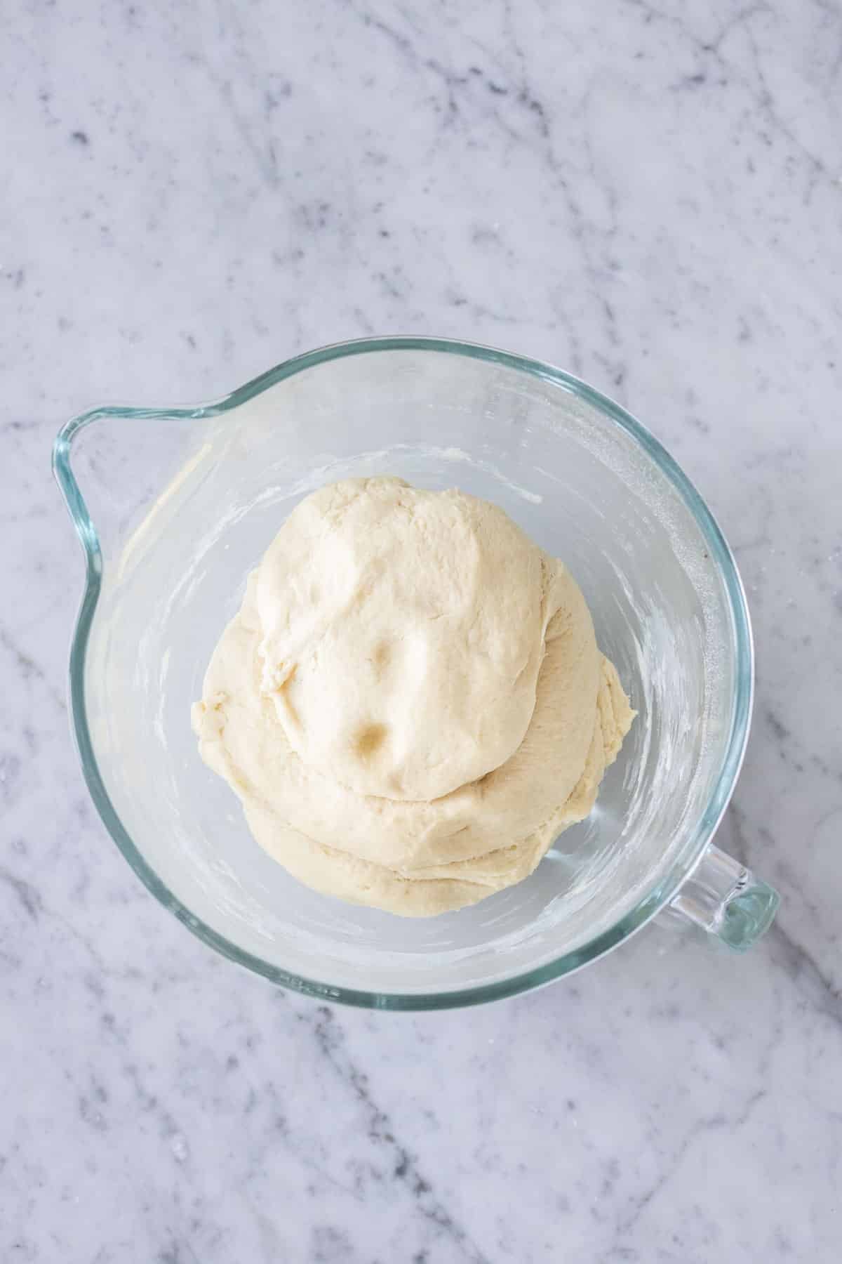 Risen yeast dough in a pan.
