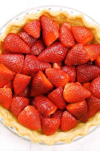Strawberries arranged in pie shell.
