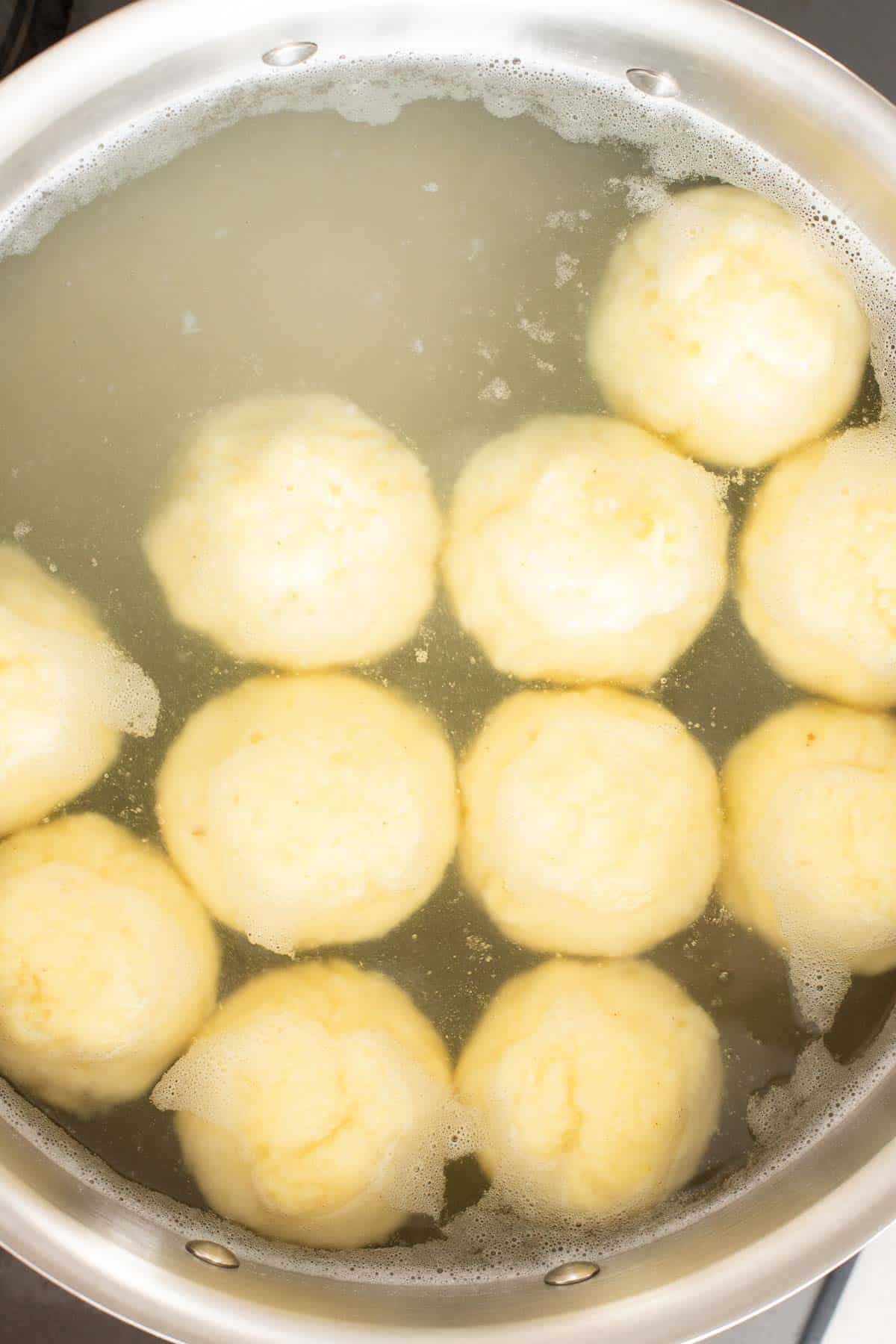 Potato dumplings swimming on the water surface.