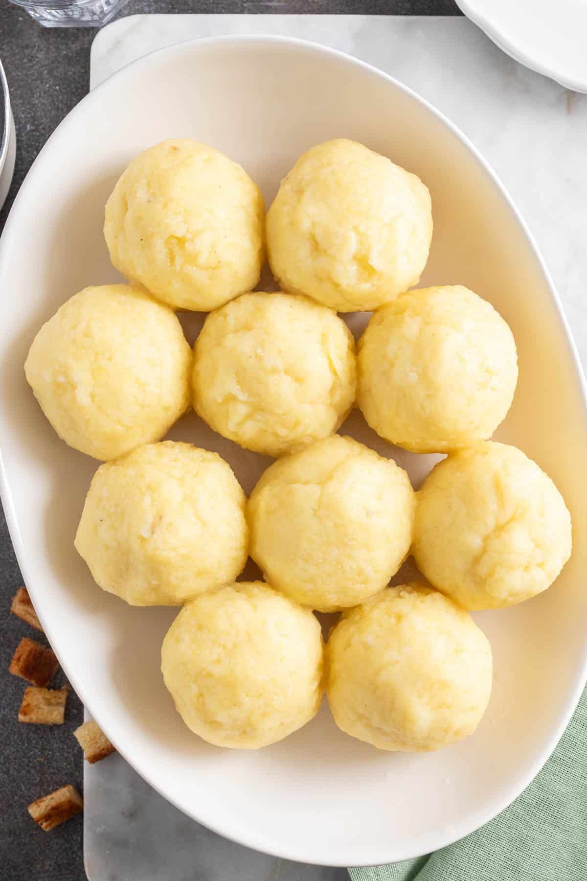 German potato dumplings on a serving plate.