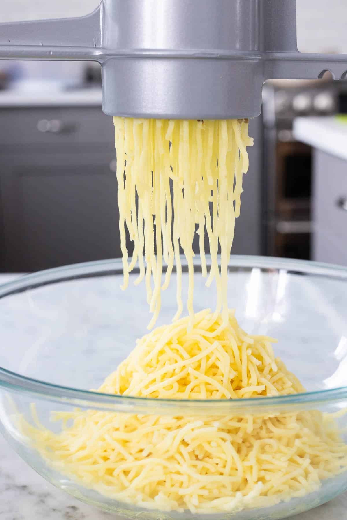Cooked potatoes going through a potato riser. 