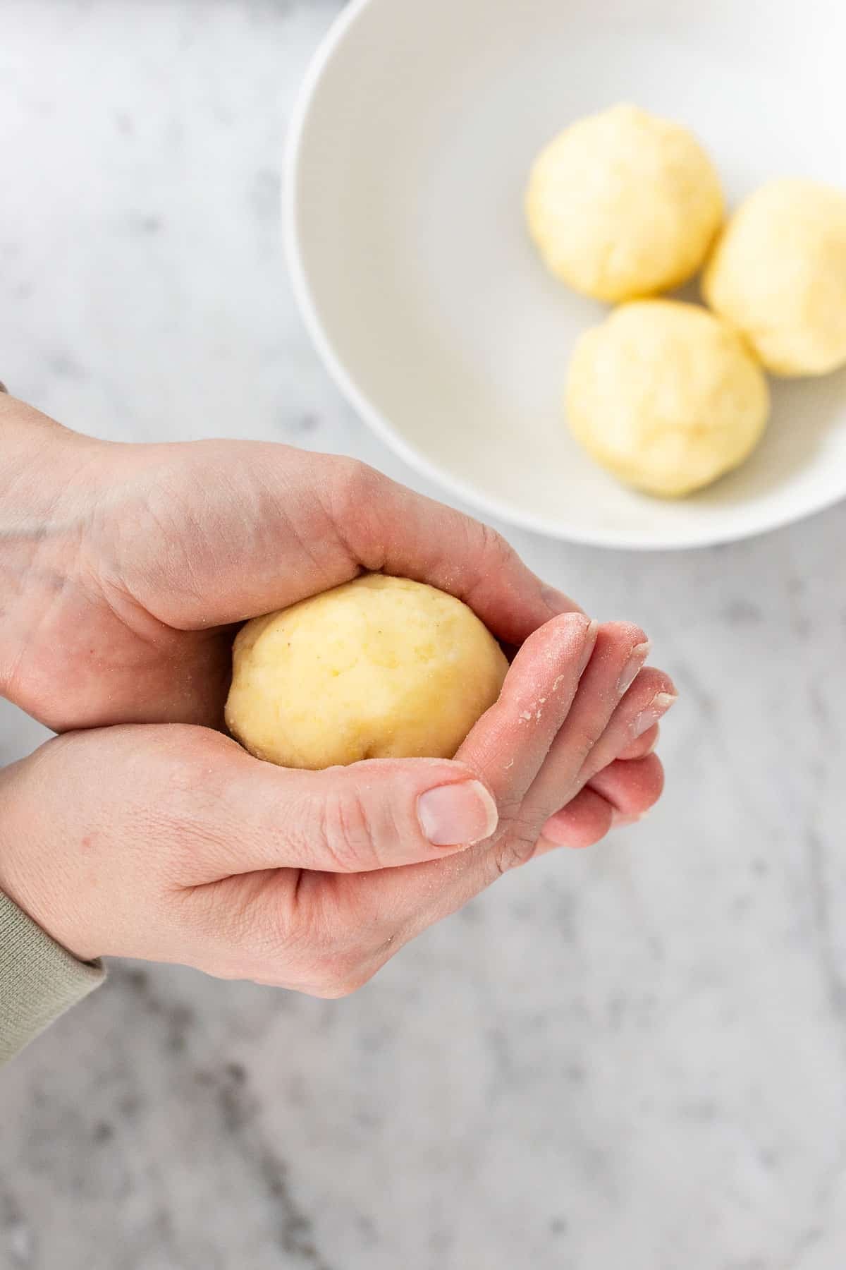 Shaping potato dumplings.