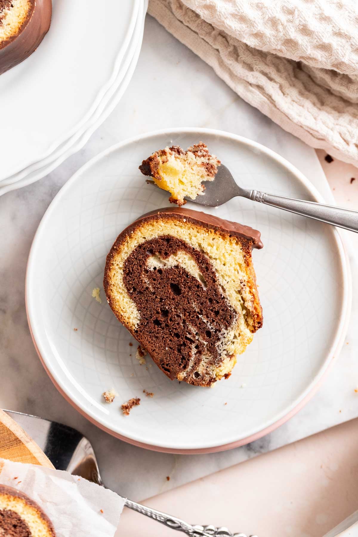 A slice of marble cake on a plate.