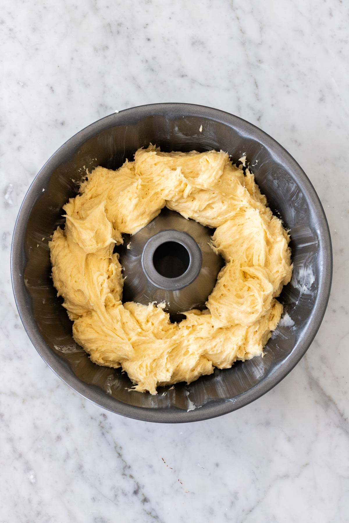 Vanilla batter in a cake pan.