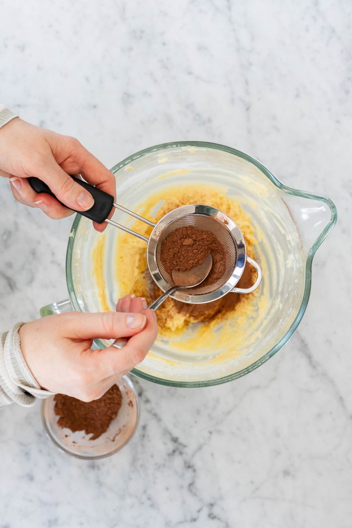 Sifting cocoa powder.