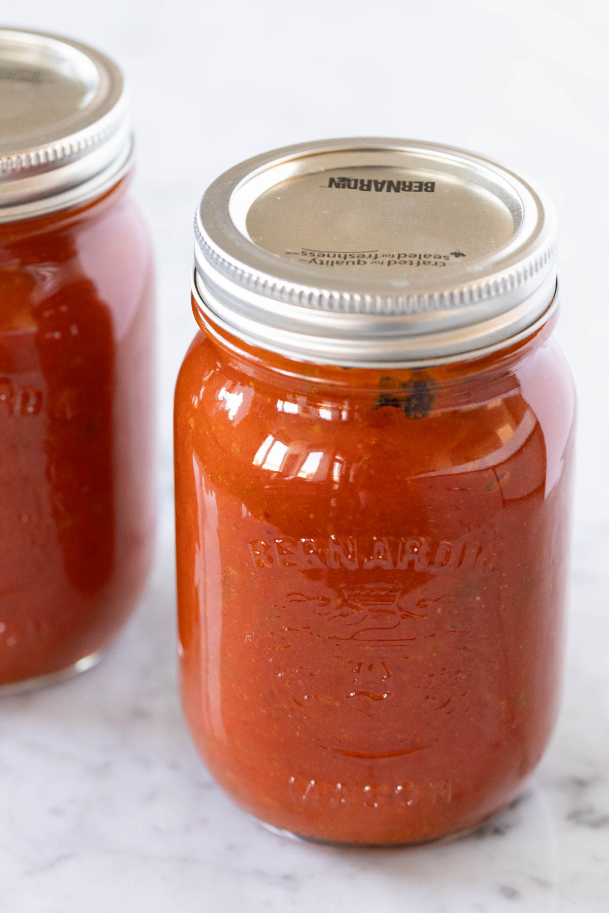 Jars of homemade currywurst sauce for easy meal prep and freezing.