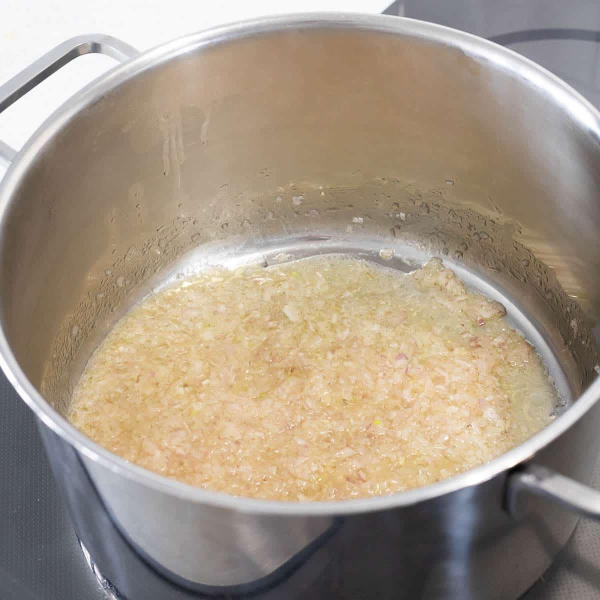 Onions cooking in a saucepan.