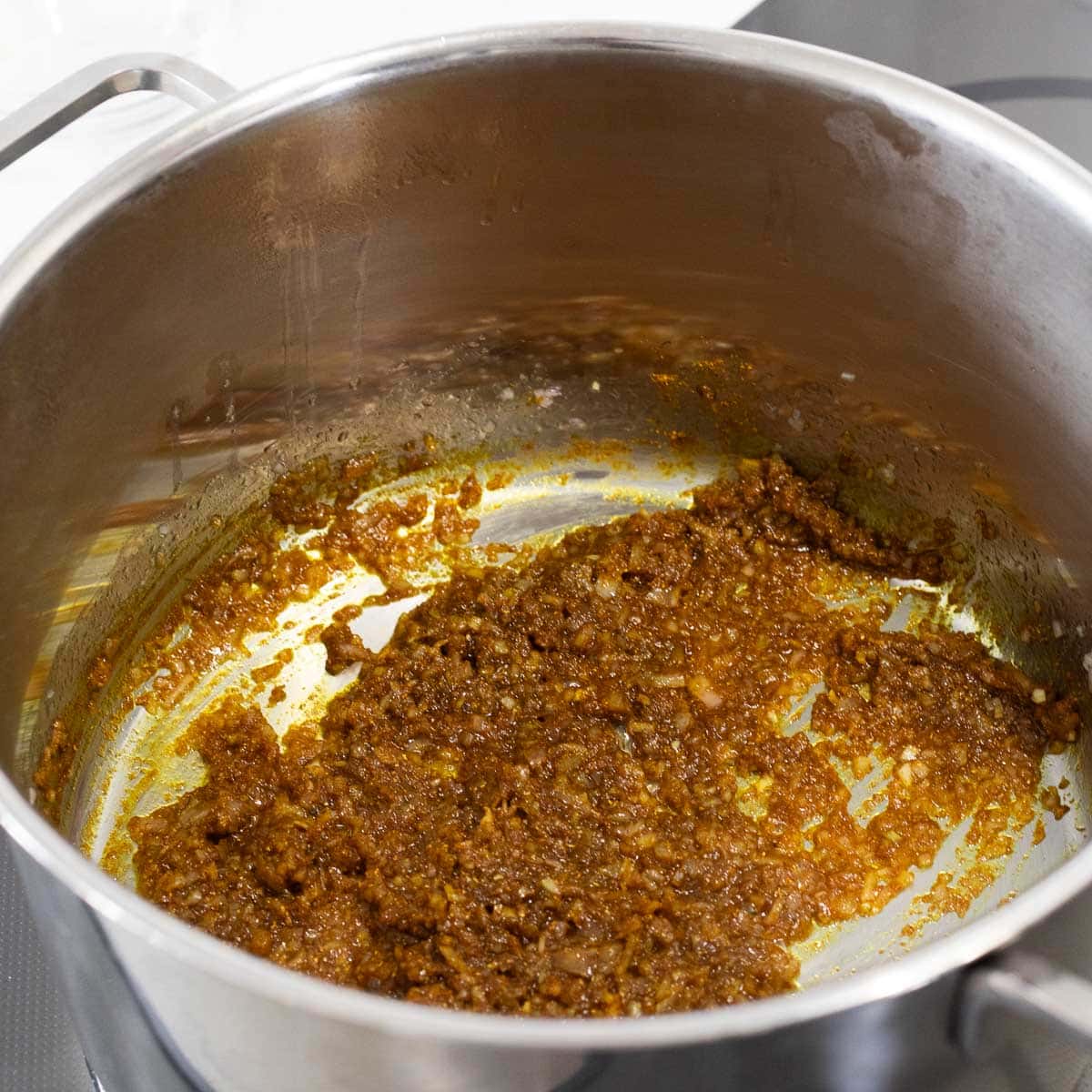 Onions and curry powder in a pot.